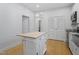 Bright kitchen featuring white cabinets, a butcher block island, and stainless appliances at 1916 Hart St, Durham, NC 27703