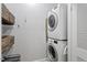 Convenient laundry room features stacked washer and dryer, plus storage baskets at 1916 Hart St, Durham, NC 27703