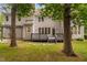 Picturesque backyard featuring mature trees, a deck, and lush greenery, perfect for outdoor living at 202 Stoneleigh Dr, Cary, NC 27511