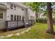 Expansive backyard with a deck, patio, and lush greenery, ideal for outdoor enjoyment at 202 Stoneleigh Dr, Cary, NC 27511