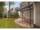 Cozy backyard patio with a stone floor and pergola, perfect for outdoor relaxation at 202 Stoneleigh Dr, Cary, NC 27511