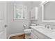 Bathroom featuring a single sink vanity, white cabinetry, and a window for natural light at 202 Stoneleigh Dr, Cary, NC 27511