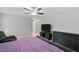 A primary bedroom with a ceiling fan, gray walls, carpet and dark furniture, including a dresser and TV at 202 Stoneleigh Dr, Cary, NC 27511