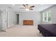 Bedroom featuring neutral walls, ceiling fan, a dresser, and natural light from a large window at 202 Stoneleigh Dr, Cary, NC 27511
