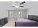 This bedroom features a ceiling fan, neutral walls, carpet floors and two windows for plenty of light at 202 Stoneleigh Dr, Cary, NC 27511