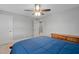 Bedroom featuring a ceiling fan, light walls, carpet, and a light-wood dresser and bed with a blue comforter at 202 Stoneleigh Dr, Cary, NC 27511