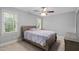 Comfortable bedroom with neutral walls, carpet, ceiling fan, and natural light from two windows at 202 Stoneleigh Dr, Cary, NC 27511