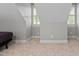 Bedroom featuring neutral walls, angled ceilings, and natural light from a window at 202 Stoneleigh Dr, Cary, NC 27511