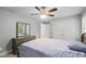 Comfortable bedroom with neutral walls, carpet, ceiling fan, a dresser with mirror, and closet at 202 Stoneleigh Dr, Cary, NC 27511
