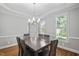 Dining room with wainscoting, hardwood floors, and a chandelier above the table at 202 Stoneleigh Dr, Cary, NC 27511