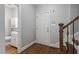Entryway featuring hardwood floors, access to bathroom, and stairs to upper floors at 202 Stoneleigh Dr, Cary, NC 27511