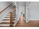 Elegant foyer with hardwood floors and staircase leading to a naturally lit hallway at 202 Stoneleigh Dr, Cary, NC 27511
