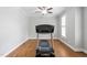 A home gym featuring hardwood floors, neutral paint, and a treadmill at 202 Stoneleigh Dr, Cary, NC 27511