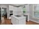 Bright white kitchen with stainless steel appliances and island with cooktop at 202 Stoneleigh Dr, Cary, NC 27511