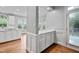 An open-plan kitchen area showcases white cabinetry, bright countertops and an open view to the dining area at 202 Stoneleigh Dr, Cary, NC 27511