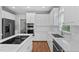 Elegant white kitchen with modern appliances, subway tile backsplash, and ample counter space at 202 Stoneleigh Dr, Cary, NC 27511