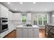 Modern kitchen with stainless steel appliances, large island, and abundant natural light at 202 Stoneleigh Dr, Cary, NC 27511