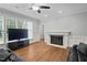 A spacious living room features a fireplace, tv on stand, hardwood floors and plenty of natural light at 202 Stoneleigh Dr, Cary, NC 27511