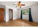 Bright bedroom featuring hardwood floors, two windows, ceiling fan, and a closet at 218 Forestville Rd, Wake Forest, NC 27587