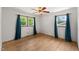 Bedroom with hardwood floors, ceiling fan, and two windows offering natural light at 218 Forestville Rd, Wake Forest, NC 27587