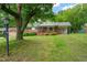 Charming single story home with a well-manicured lawn, mature trees, a front porch and a side carport at 218 Forestville Rd, Wake Forest, NC 27587