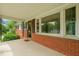 Charming covered front porch with brick facade and decorative wrought iron columns at 218 Forestville Rd, Wake Forest, NC 27587