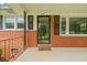 Inviting front porch with brick accents and a glass storm door at 218 Forestville Rd, Wake Forest, NC 27587