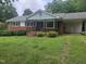 Charming brick home with a well-manicured front yard and covered porch at 218 Forestville Rd, Wake Forest, NC 27587
