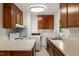 Cozy kitchen featuring wooden cabinets, white appliances, and a double basin sink, bathed in natural light at 218 Forestville Rd, Wake Forest, NC 27587