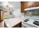 Bright eat-in kitchen features a white range with complementing countertops and a view of the back yard at 218 Forestville Rd, Wake Forest, NC 27587