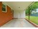 Covered back patio with brick siding and ample outdoor space at 218 Forestville Rd, Wake Forest, NC 27587