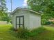 A backyard storage shed with a wood exterior with black trim at 218 Forestville Rd, Wake Forest, NC 27587