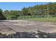 Outdoor basketball court with chain-link fence in a well-maintained community with mature trees at 224 Kirkwood Dr, Chapel Hill, NC 27514