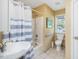 Cozy bathroom featuring a shower/tub, toilet, sink, and blue and white striped shower curtain at 224 Kirkwood Dr, Chapel Hill, NC 27514
