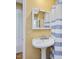 Bathroom featuring a vintage pedestal sink and white cabinet with yellow walls at 224 Kirkwood Dr, Chapel Hill, NC 27514