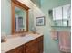 Bathroom with wooden vanity, neutral countertops, and framed mirror at 224 Kirkwood Dr, Chapel Hill, NC 27514