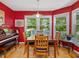 Bright dining room with large windows, hardwood floors, and a classic table setting for Gathering meals at 224 Kirkwood Dr, Chapel Hill, NC 27514
