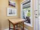 Sunlit entryway features a wooden table, window, and view to the outdoor deck at 224 Kirkwood Dr, Chapel Hill, NC 27514