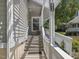 Covered front porch with stairs and white railings, providing a welcoming entrance to the home at 224 Kirkwood Dr, Chapel Hill, NC 27514