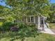 Charming home featuring mature trees, lush landscaping, and a convenient ramp to the front entrance at 224 Kirkwood Dr, Chapel Hill, NC 27514