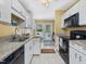 Well-lit kitchen features granite counters, white cabinetry, and a full suite of appliances at 224 Kirkwood Dr, Chapel Hill, NC 27514