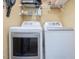 Efficient laundry room with side-by-side washer and dryer units and ample storage space at 224 Kirkwood Dr, Chapel Hill, NC 27514