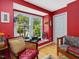 Bright living room featuring hardwood floors, a large window, and a cozy armchair at 224 Kirkwood Dr, Chapel Hill, NC 27514