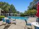Community pool with ample seating, umbrellas, and a pergola, perfect for relaxing by the water at 224 Kirkwood Dr, Chapel Hill, NC 27514