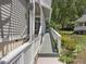 Exterior view of the home's ramp, with white railings and landscaped flower bed at 224 Kirkwood Dr, Chapel Hill, NC 27514