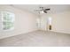 Spacious bedroom with ample natural light from large windows and a ceiling fan at 2241 Spruce Shadows Ln, Raleigh, NC 27614