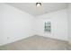 Neutral bedroom with a window providing natural light and a light carpet at 2241 Spruce Shadows Ln, Raleigh, NC 27614