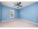Bright blue bedroom with a large window and ceiling fan at 2241 Spruce Shadows Ln, Raleigh, NC 27614