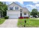 Charming two-story home with a manicured lawn, attached garage, and inviting front porch at 2241 Spruce Shadows Ln, Raleigh, NC 27614