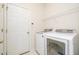 Functional laundry room featuring a side-by-side washer and dryer and storage shelving at 2241 Spruce Shadows Ln, Raleigh, NC 27614